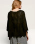 Person wearing a black textured top with a plain background