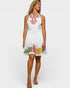 Woman wearing a white dress with floral patterns on a white background