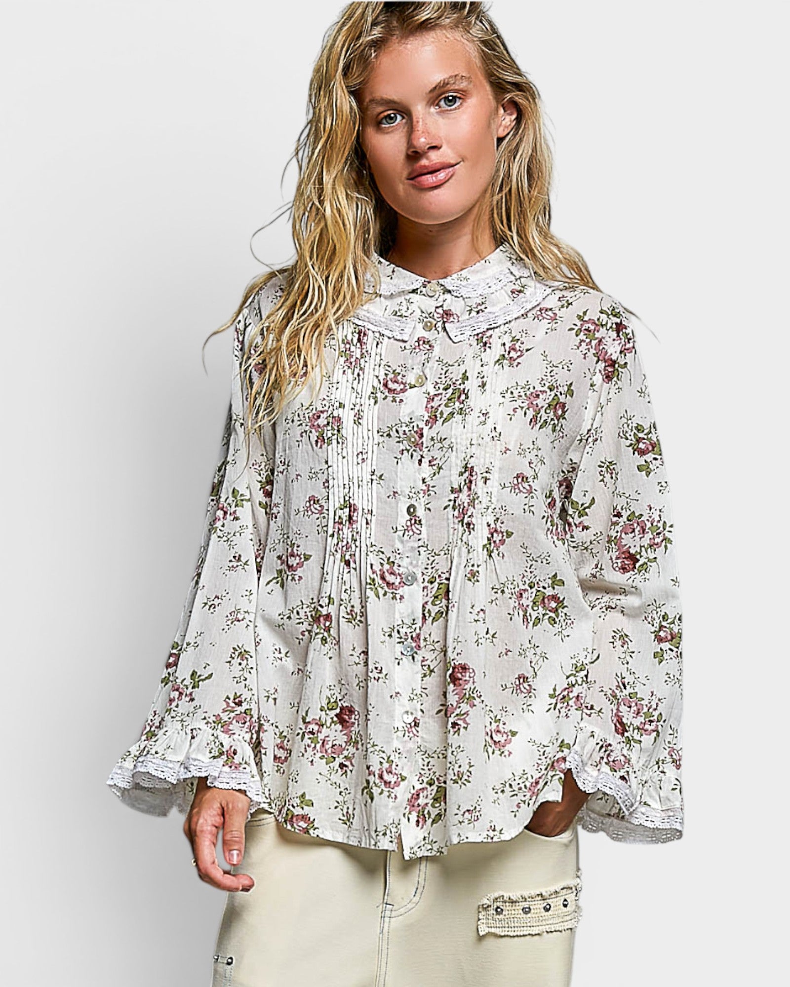 Woman wearing a floral blouse against a white background