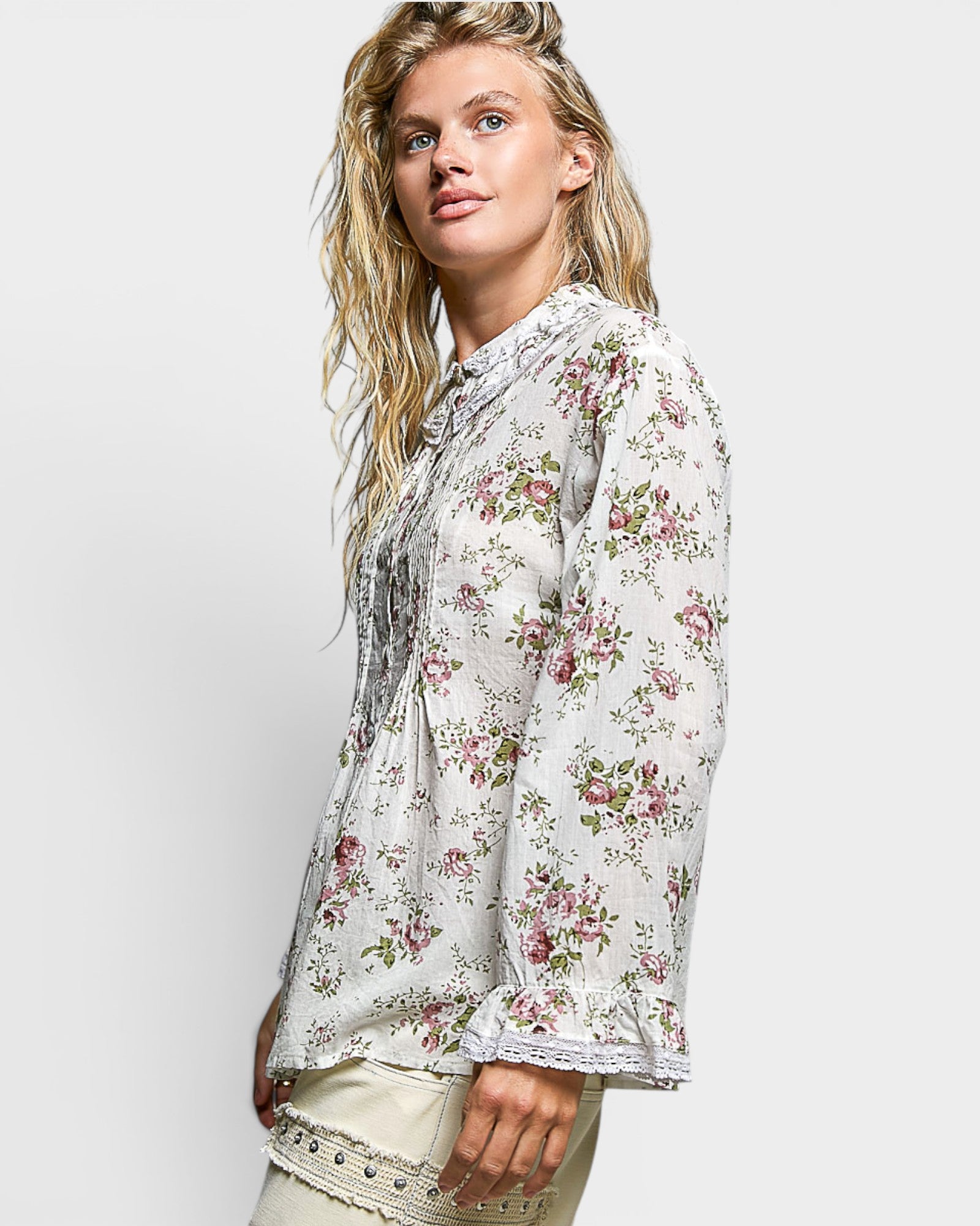 Woman wearing a floral blouse against a white background