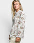 Woman wearing a floral blouse against a white background