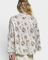Floral patterned blouse worn by a person on a white background