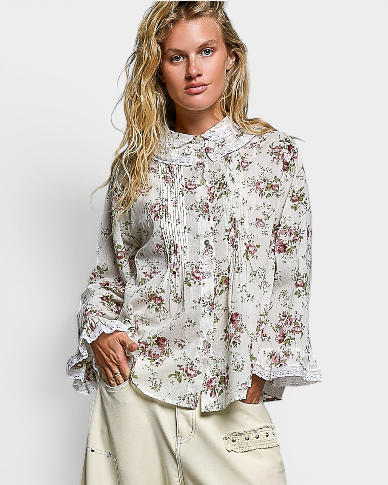 Woman wearing a floral blouse with a plain background