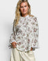 Woman wearing a floral blouse with a plain background