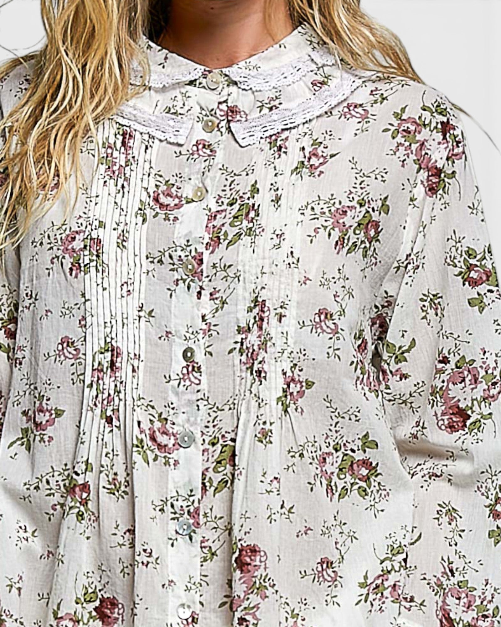 Floral patterned blouse with a focus on the fabric texture and design.