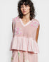 Woman wearing a pink floral dress against a white background