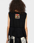 Black sleeveless top with floral pocket on a plain background
