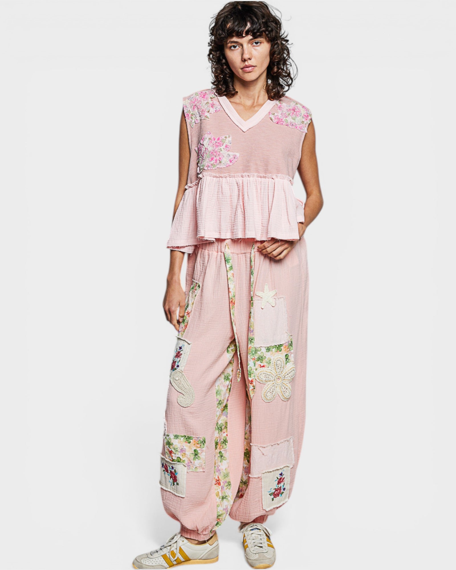 Woman wearing a pink floral outfit on a white background