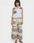 Woman wearing a layered dress with floral patterns on a white background