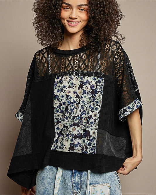 Woman wearing a black and floral top with a beige background