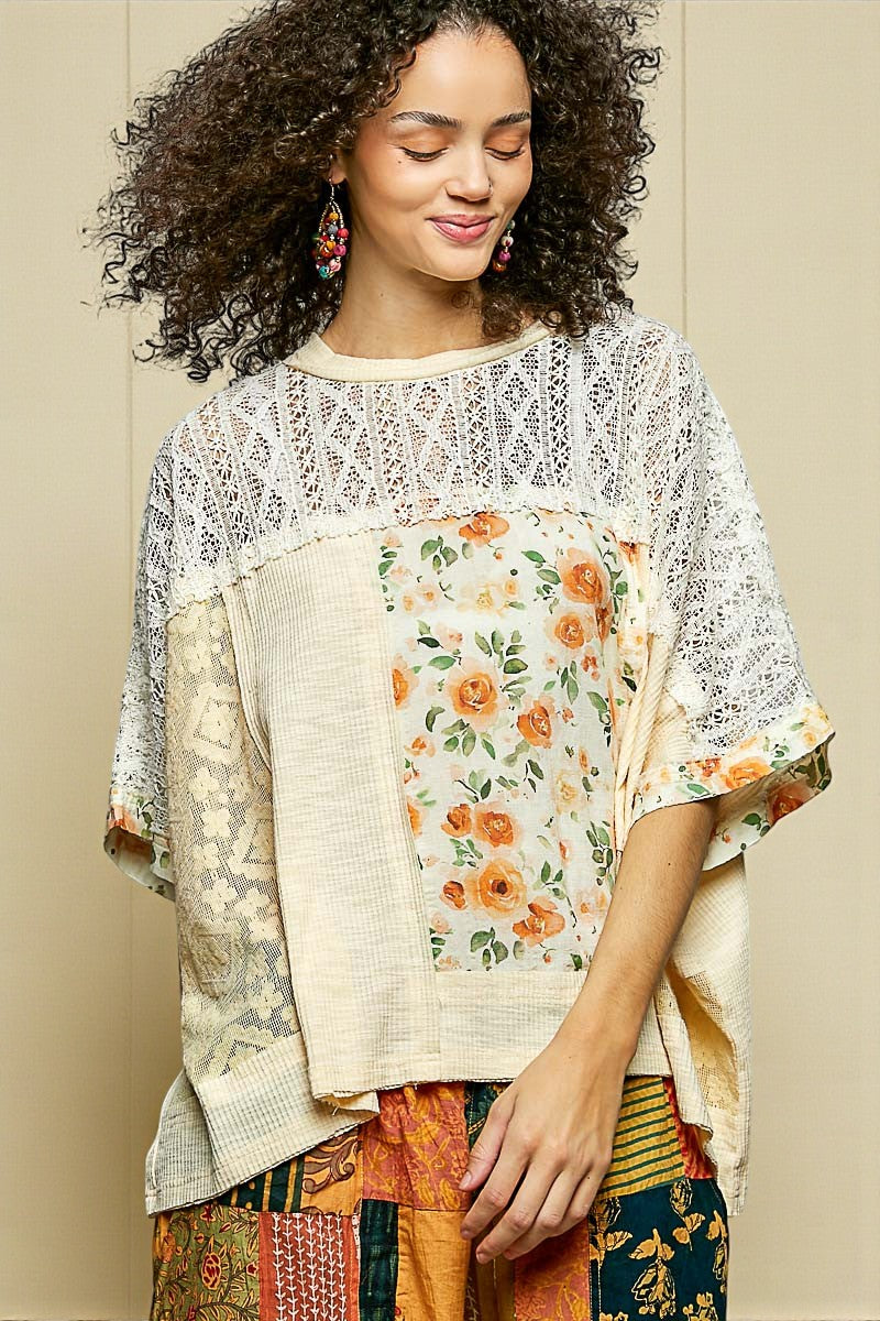 Woman wearing a floral and patterned top against a neutral background