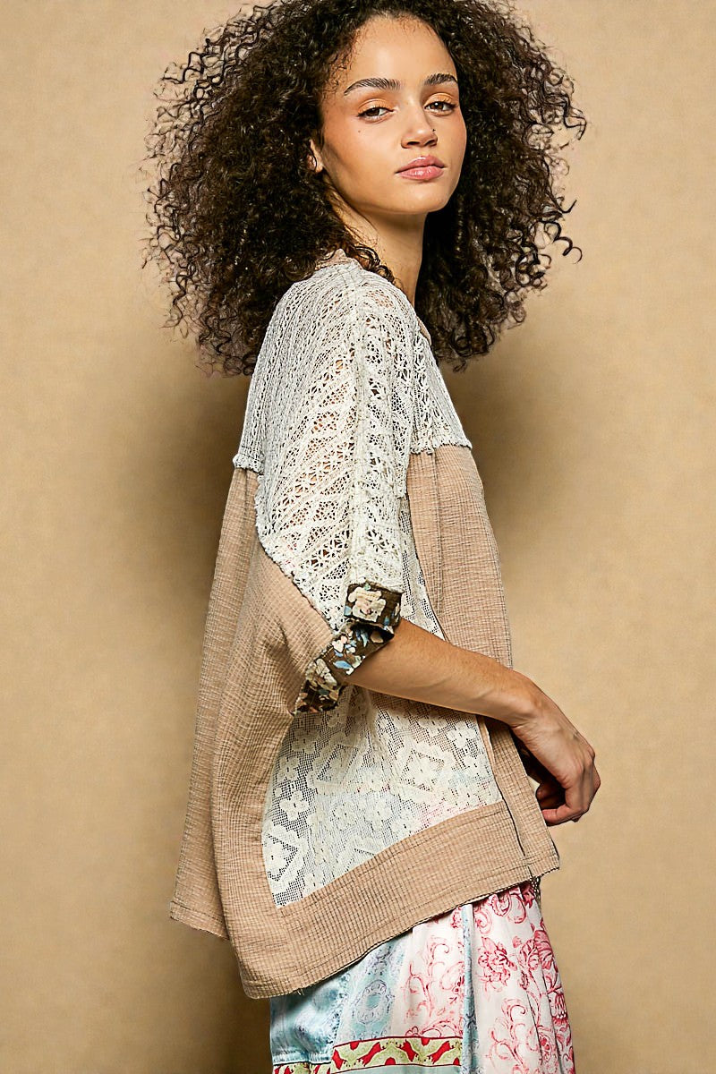 Woman wearing a beige and floral top against a beige background