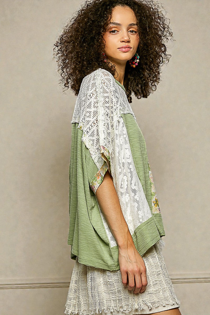 Woman wearing a green and white lace outfit against a beige background