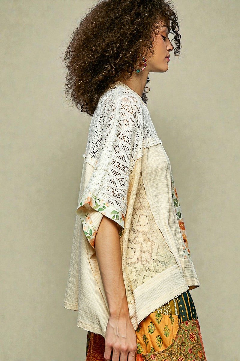 Woman wearing a floral kimono-style garment against a plain background