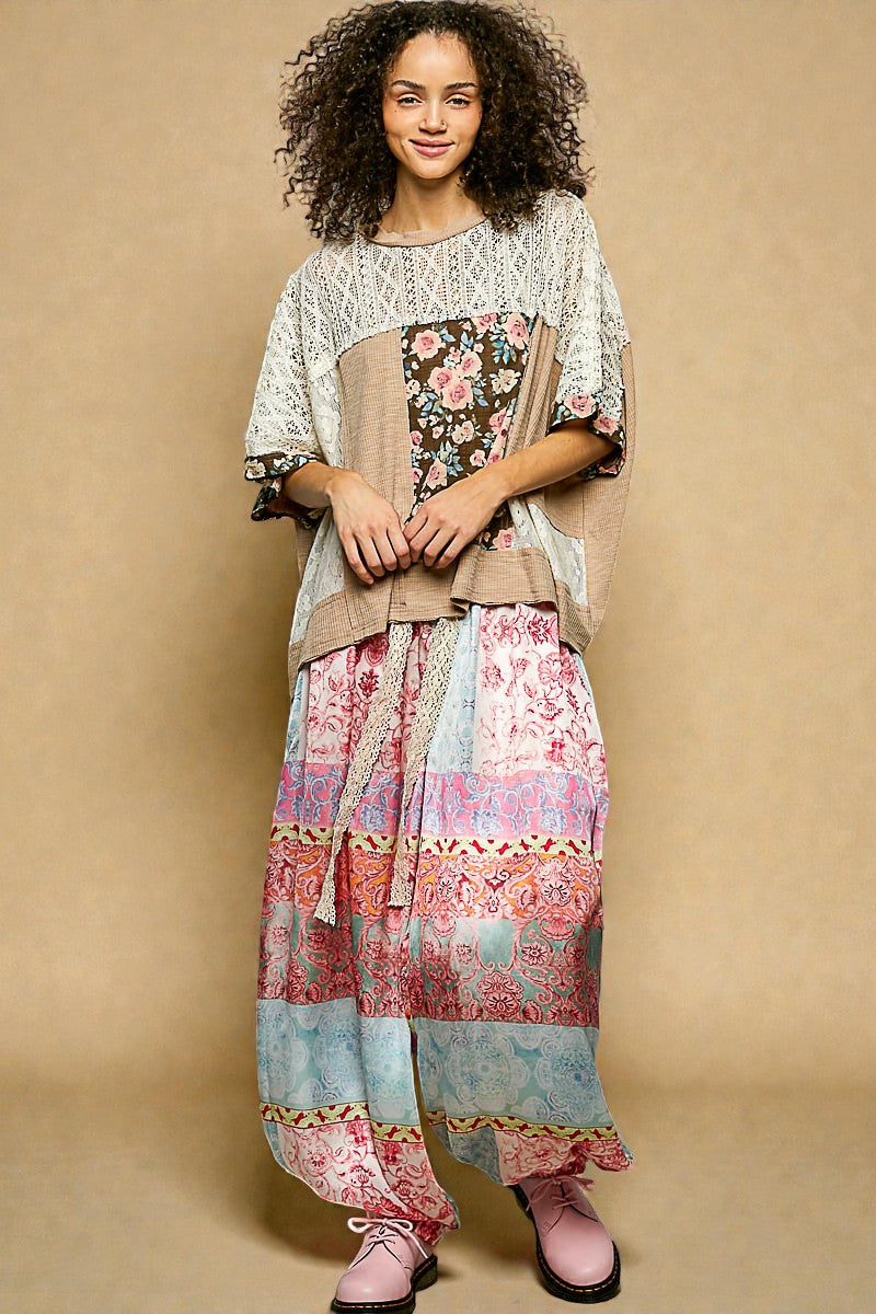 Woman wearing a colorful, patterned outfit against a beige background