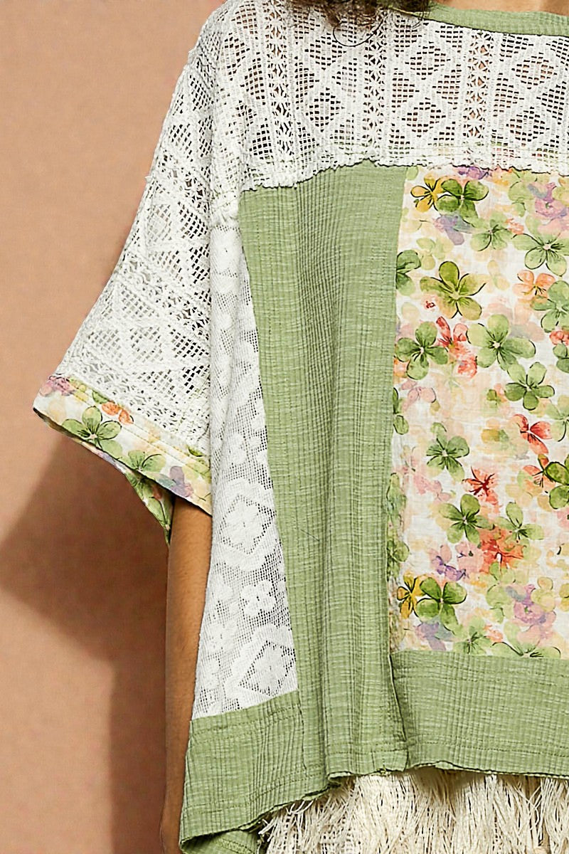 Green and white floral patterned fabric with lace details on a brown background