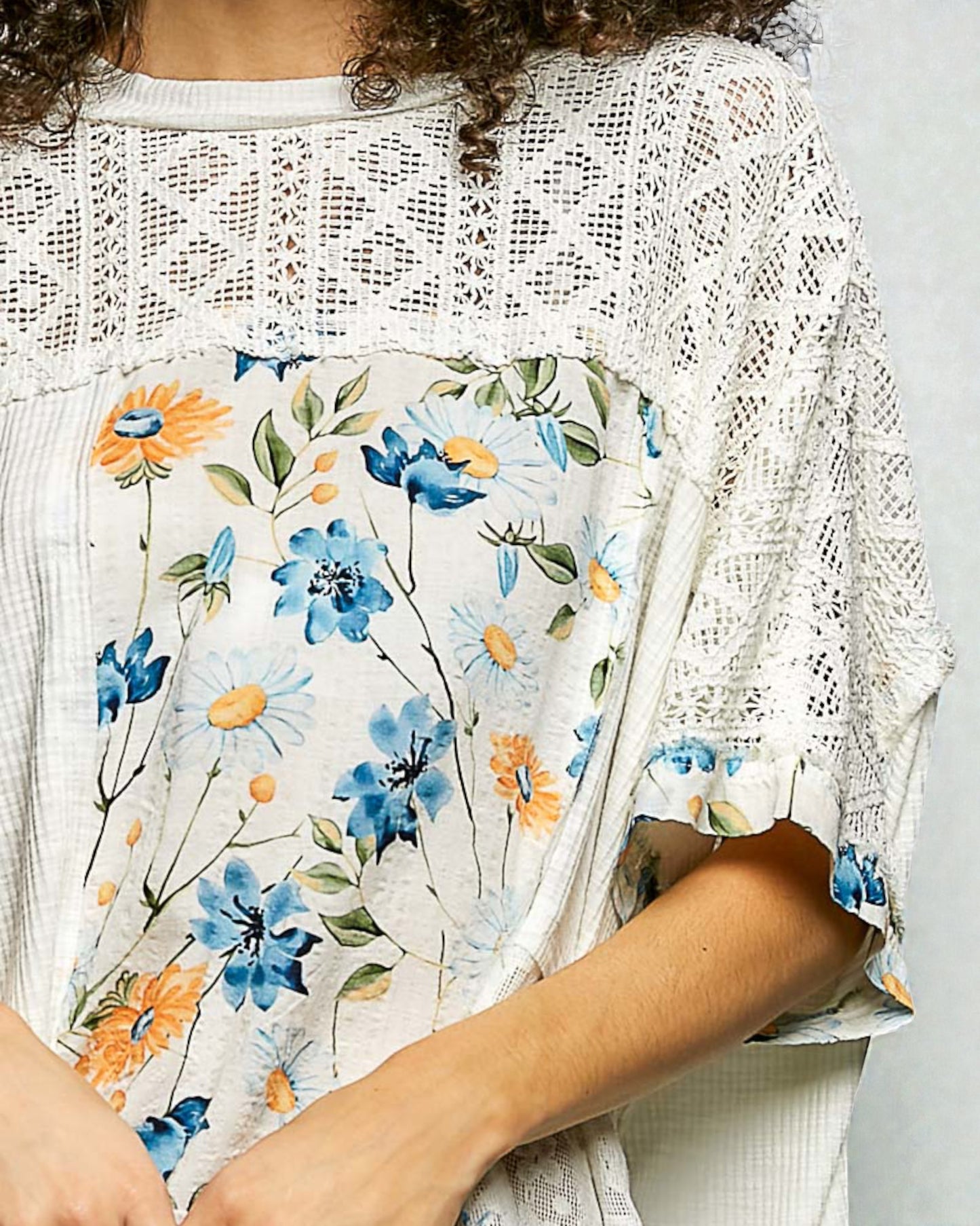 Floral-patterned garment with a white lace overlay