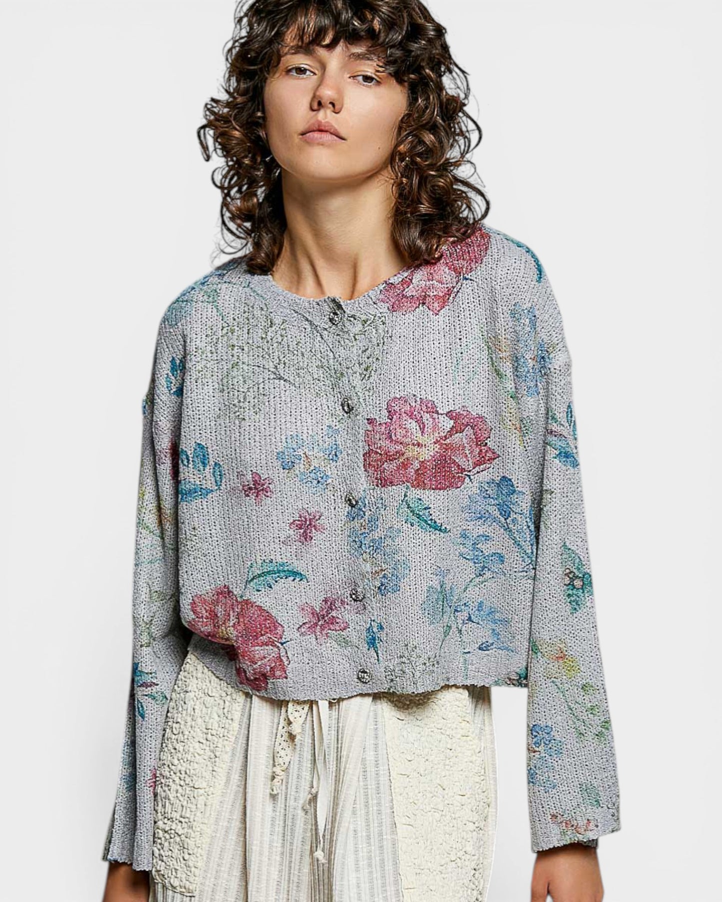 Woman wearing a floral blouse with a plain background