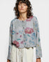 Woman wearing a floral blouse with a plain background