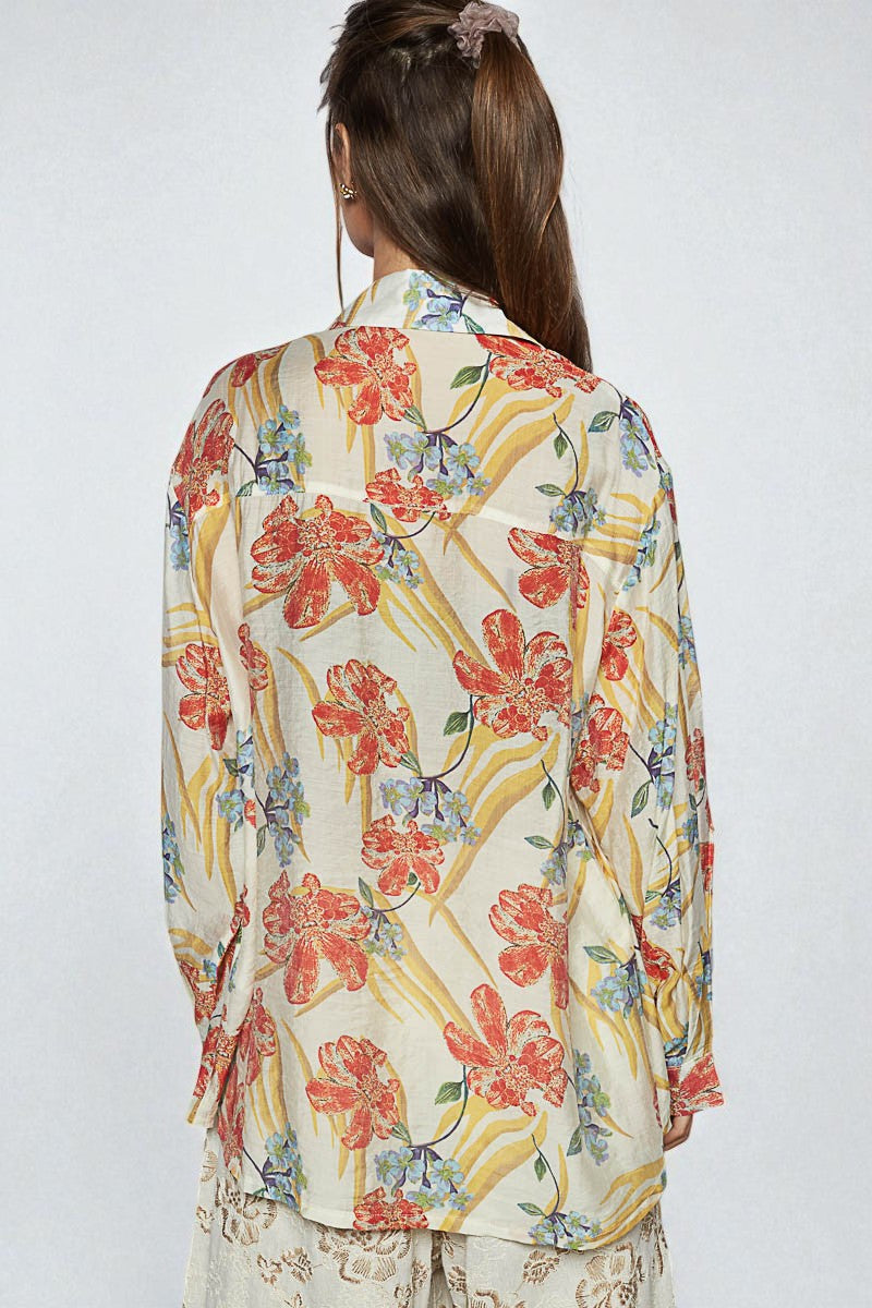 Woman wearing a floral blouse with a white background