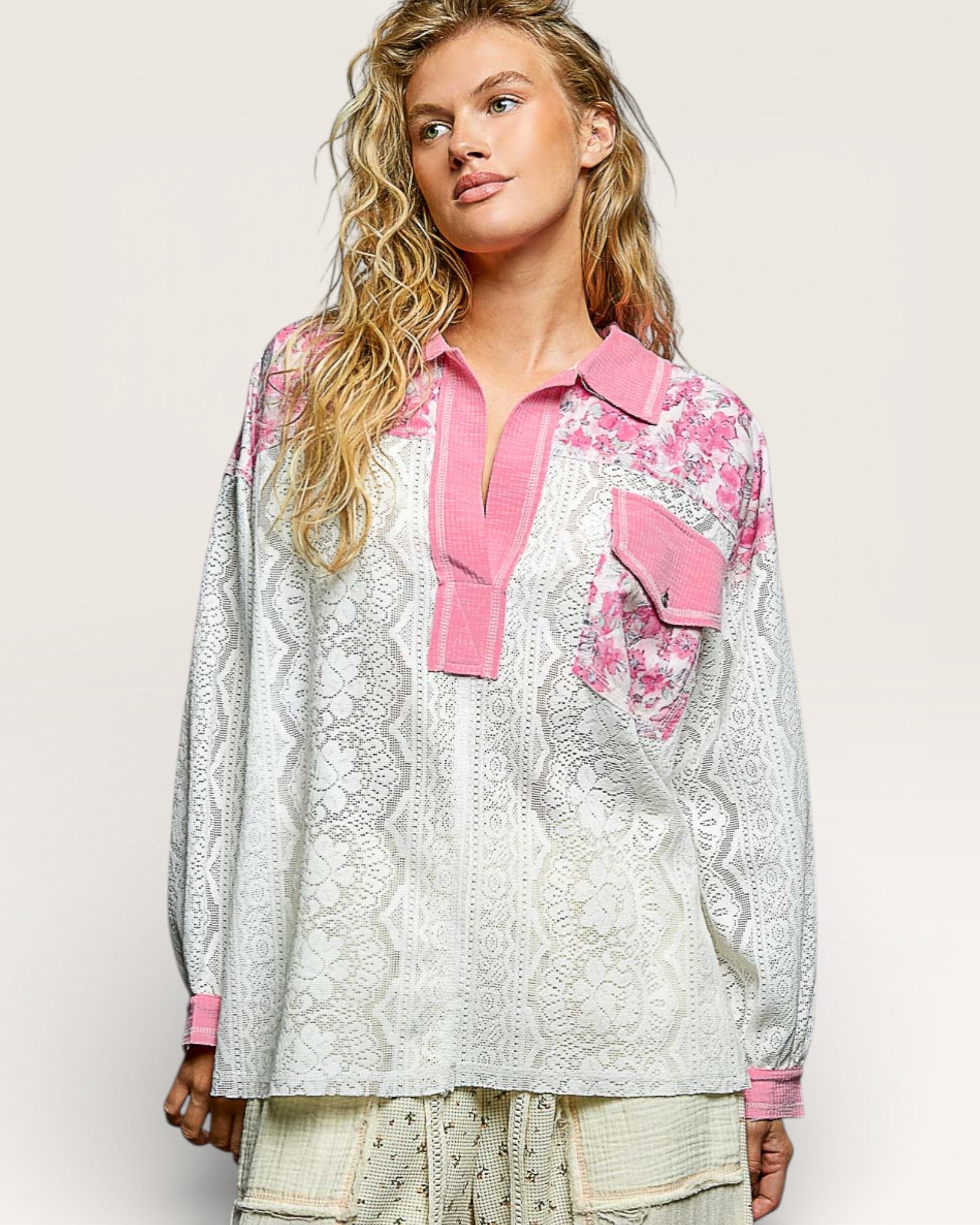 Woman wearing a floral blouse with pink accents on a white background
