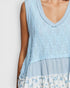 Light blue sleeveless dress with floral hem on a white background