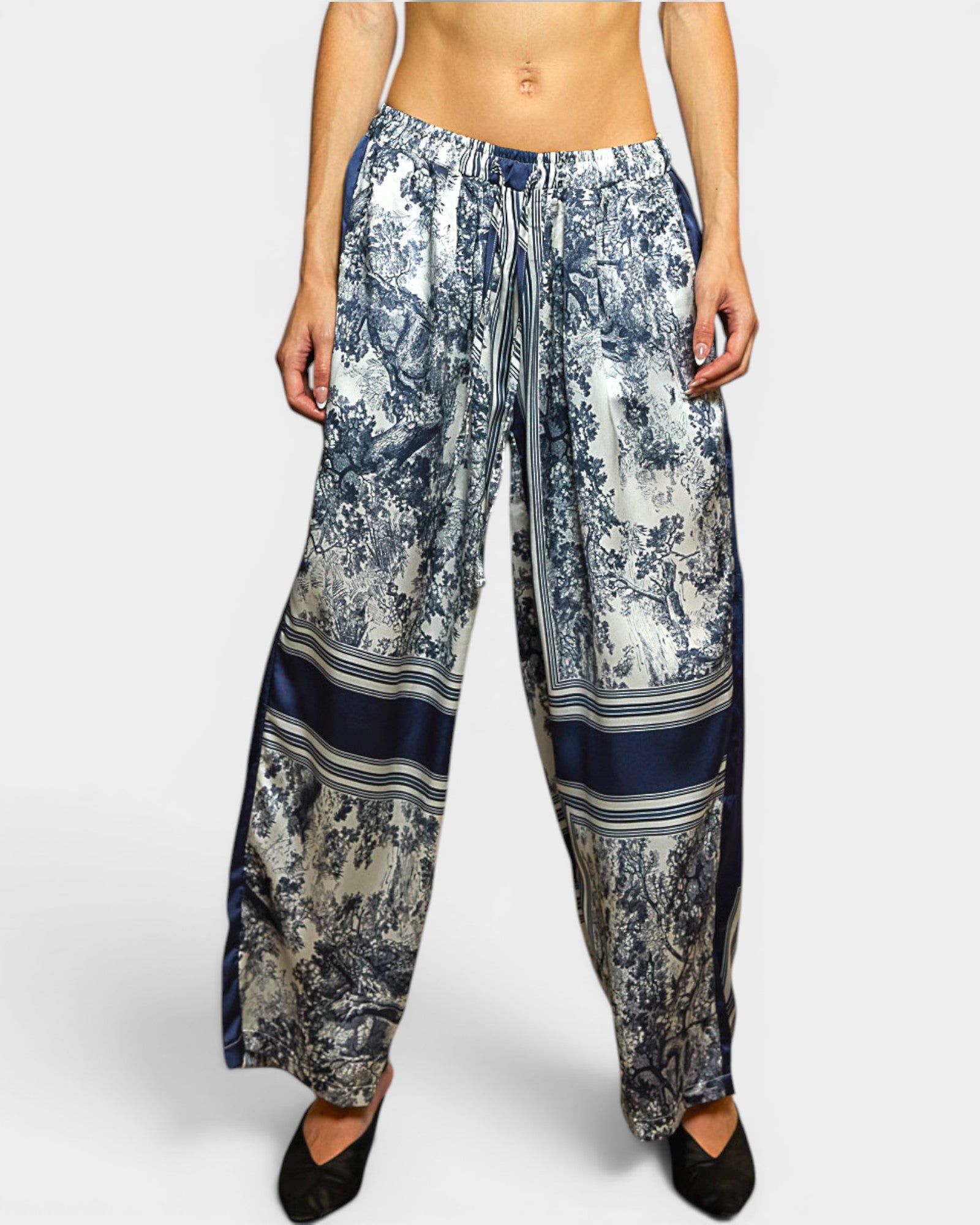 Floral-patterned pants worn by a person on a white background