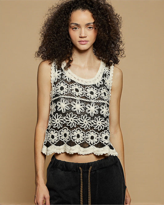 Woman wearing a black lace top against a beige background