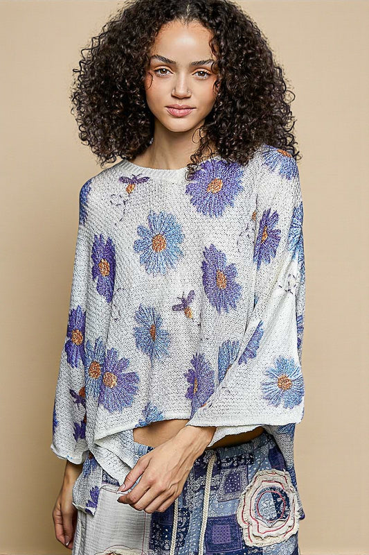 Woman wearing a floral patterned top against a beige background