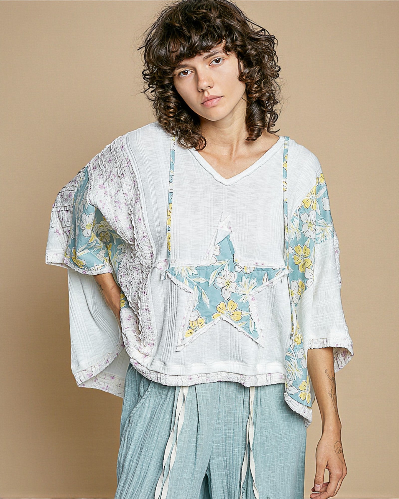 Woman wearing a floral blouse with a beige background