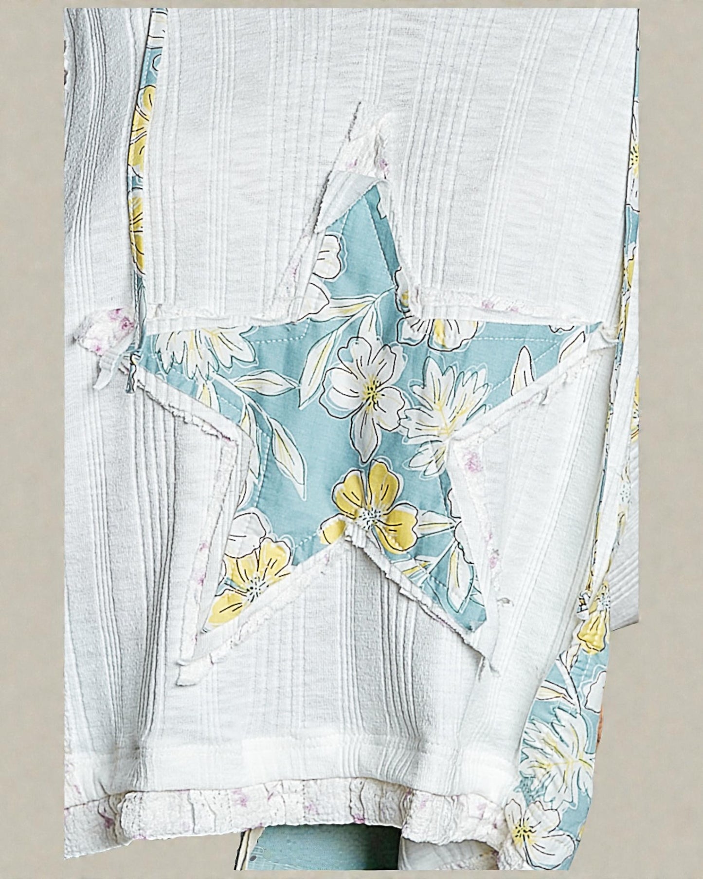 Floral dress with a blue and yellow pattern on a neutral background