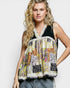 Woman wearing a colorful patchwork sleeveless top against a plain background