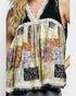 Multicolored floral patterned top with lace trim on a plain background
