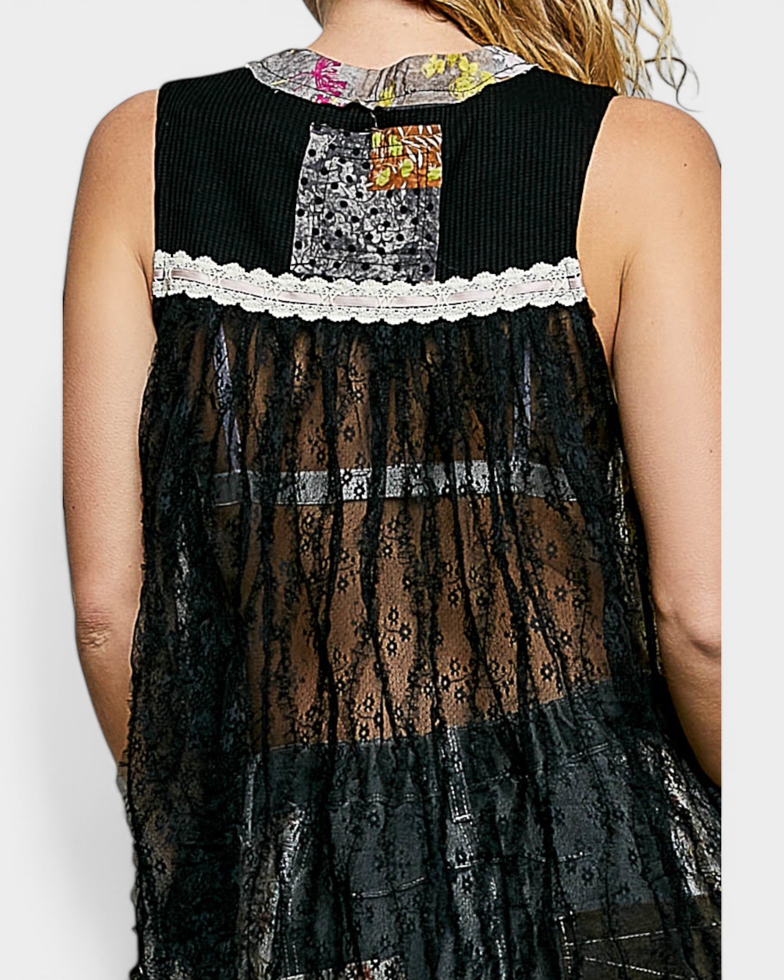 Black lace dress with colorful patchwork neckline on a white background