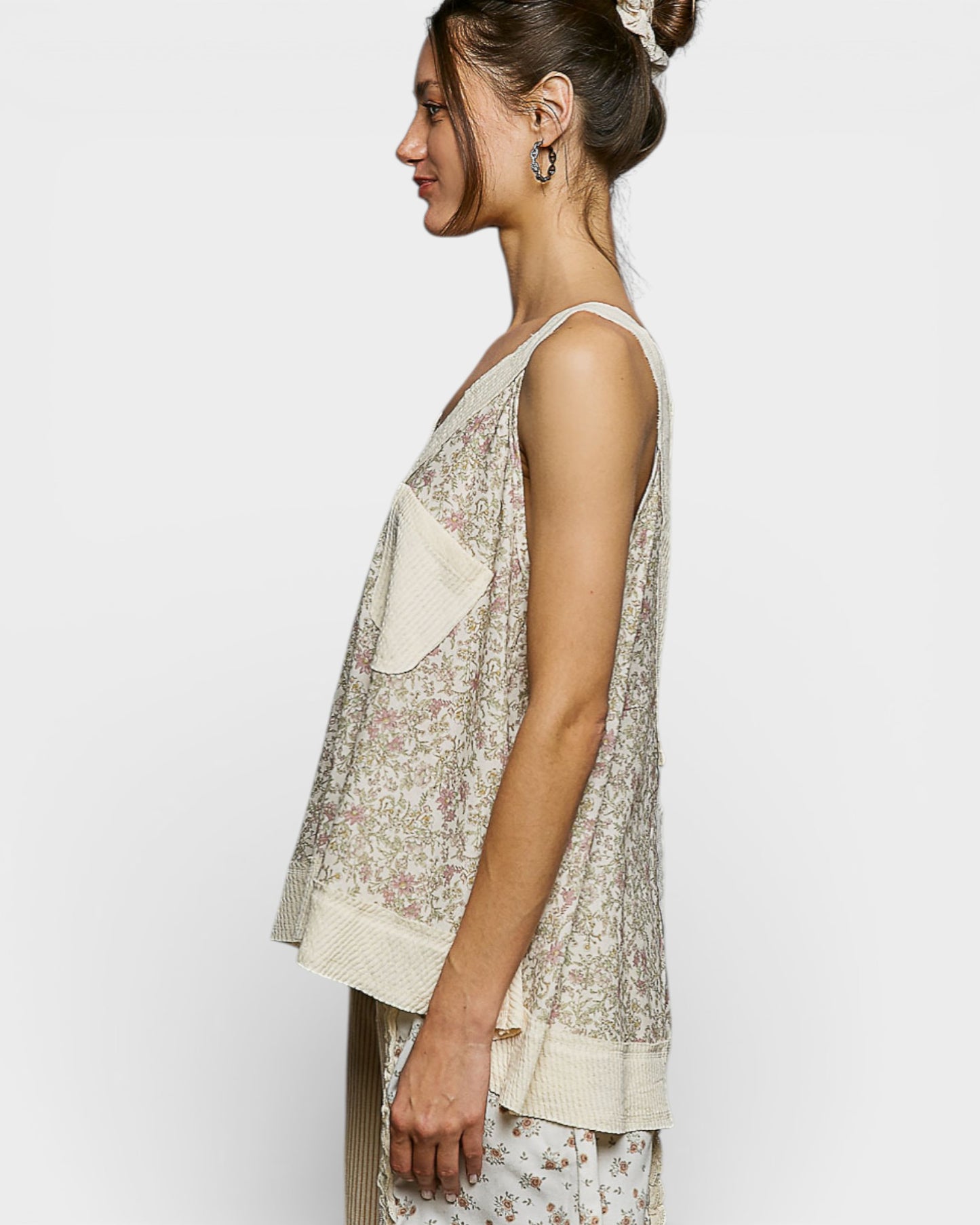 Woman wearing a floral dress with a plain background