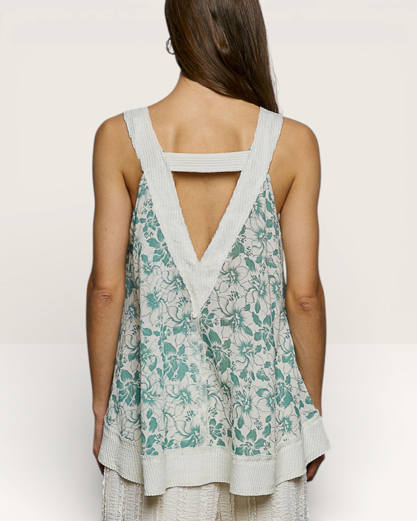 Woman wearing a floral dress with a white background