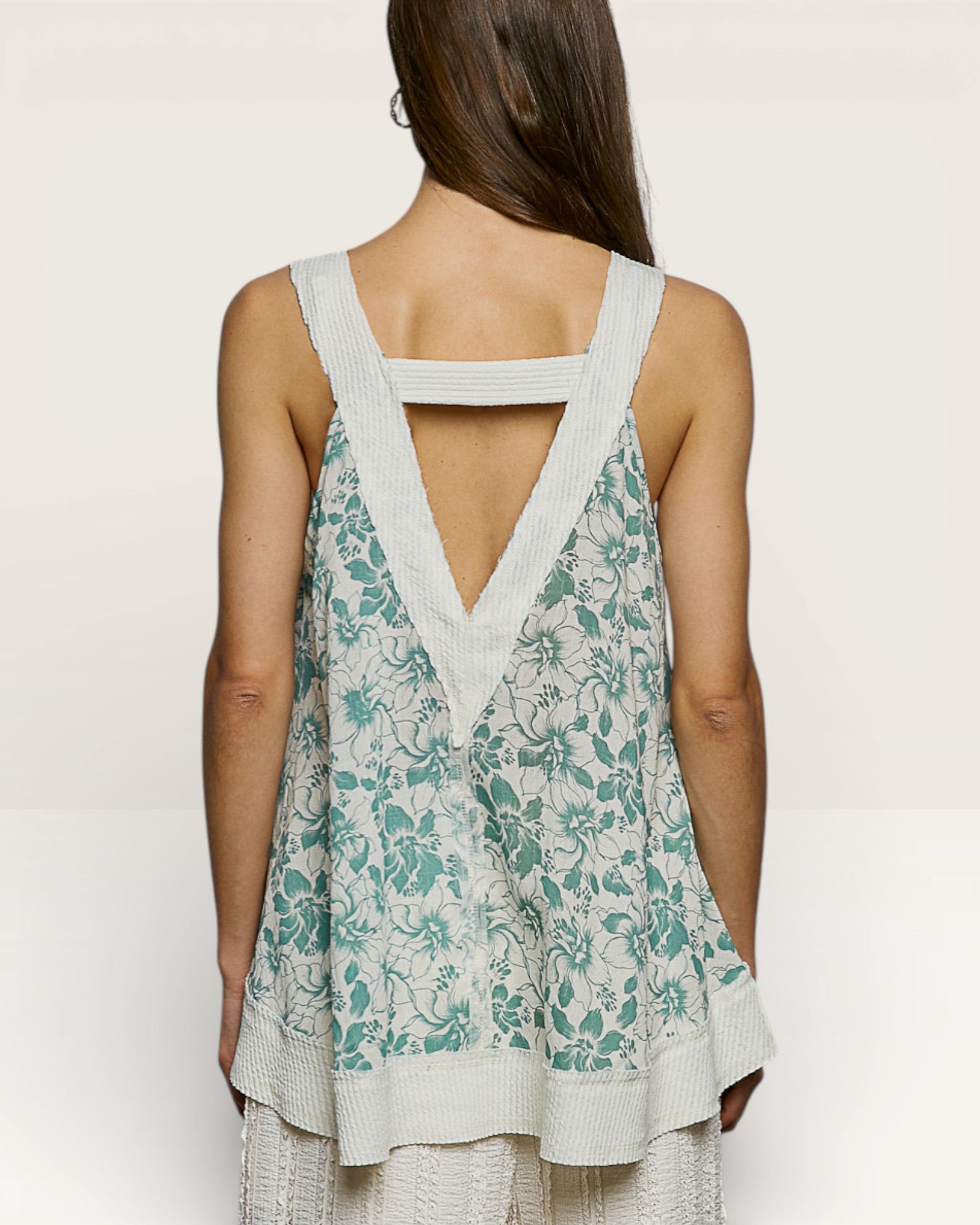 Woman wearing a floral dress with a white background