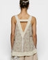Woman wearing a floral sleeveless top with a V-neckline on a white background