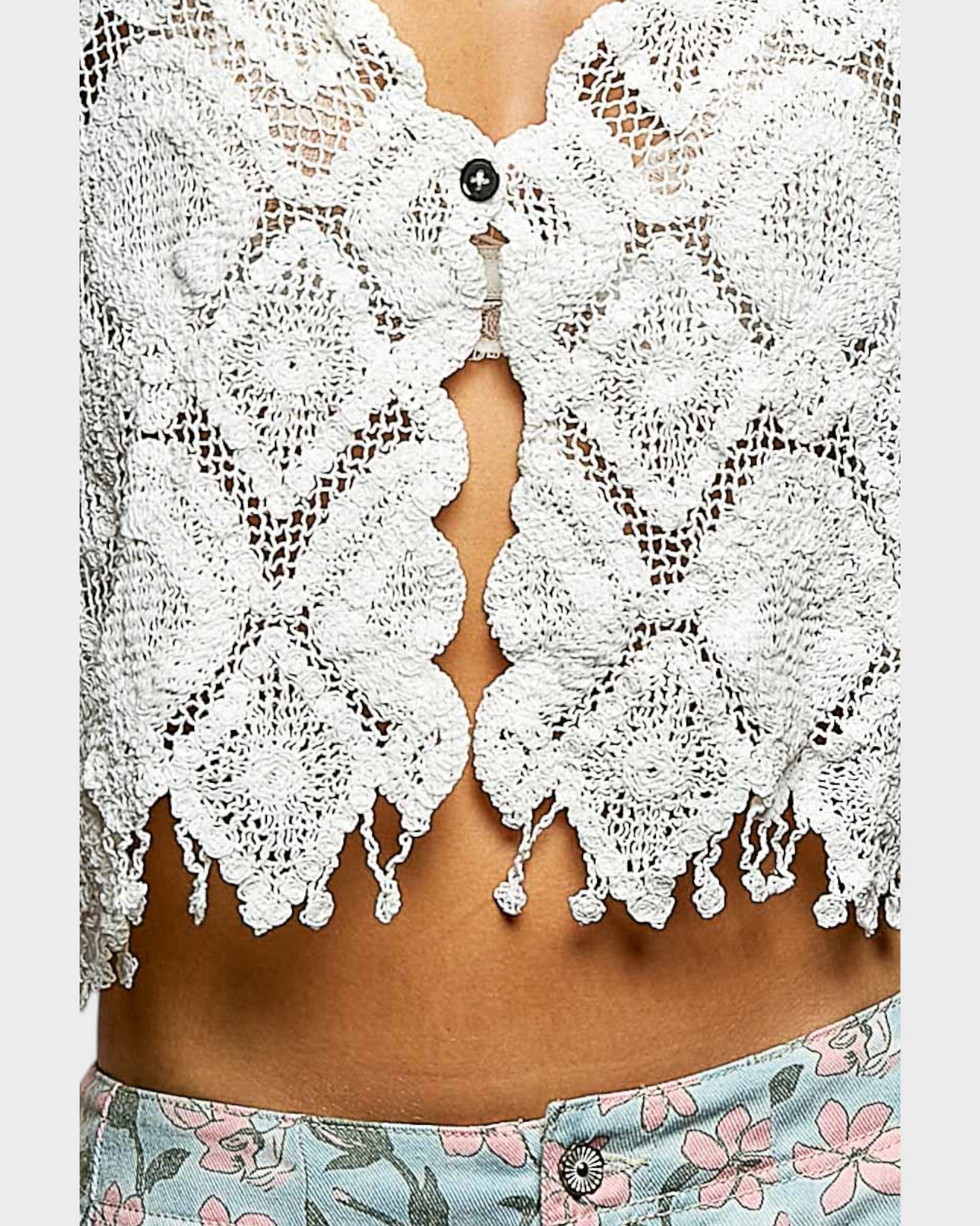White lace top with floral pants on a white background