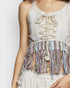 White lace top with colorful fringes on a plain background