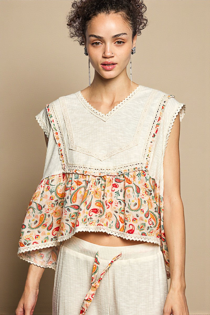 Woman wearing a floral top with a plain background