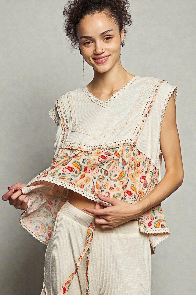 Woman wearing a floral top with a plain background