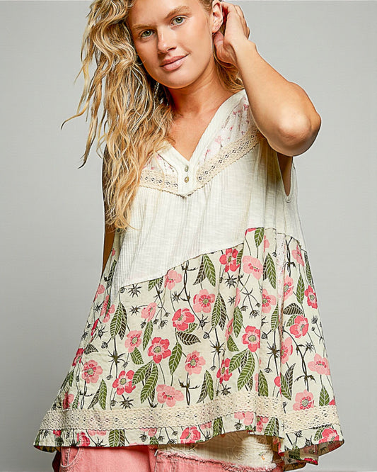 Woman wearing a floral patterned top with a plain background