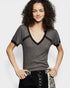 Woman wearing a gray short-sleeve top with lace trim on a white background