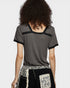 Person wearing a gray textured top with black trim on a white background