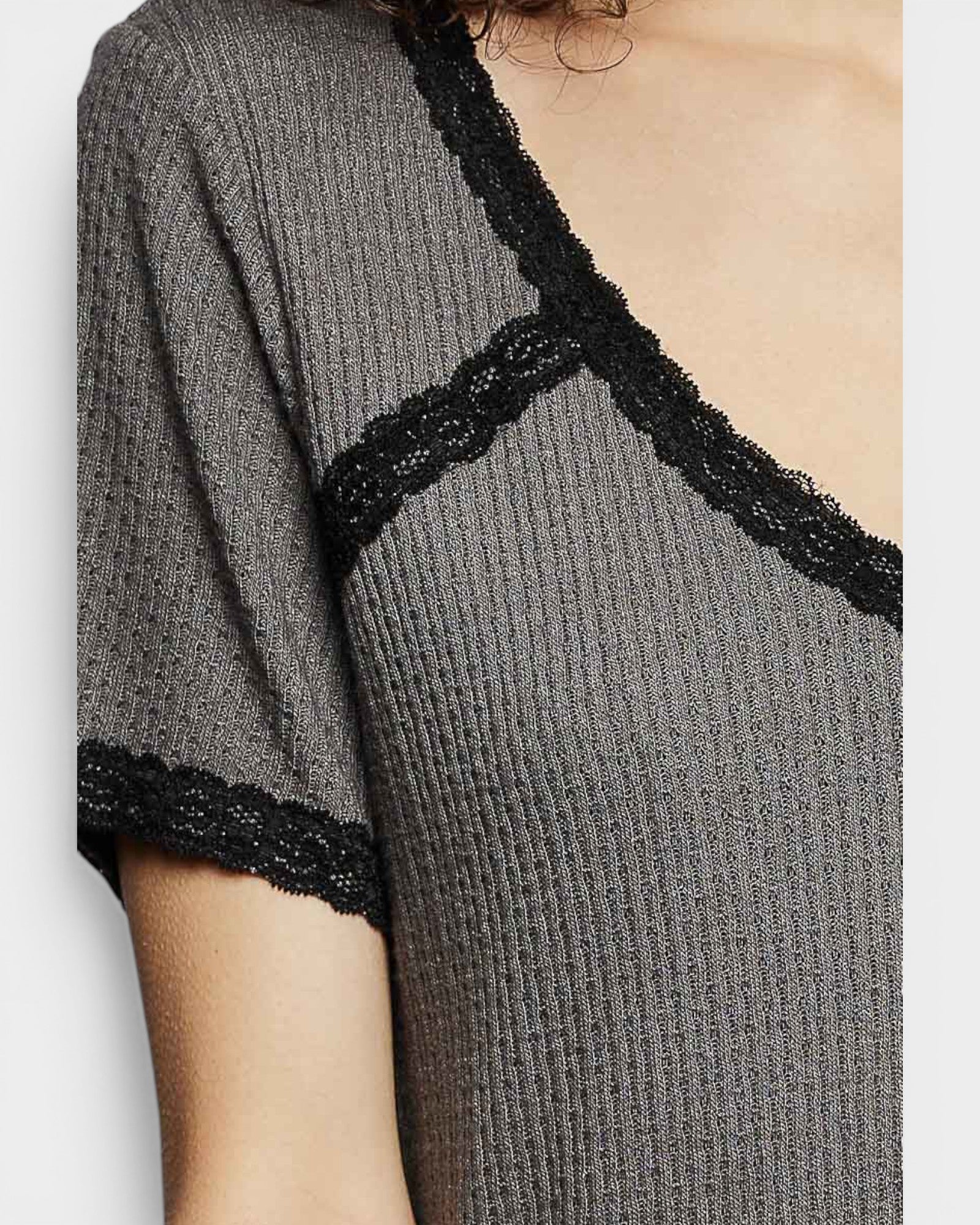Gray ribbed sweater with black lace trim on a plain background