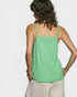 Woman wearing a green tank top against a white background