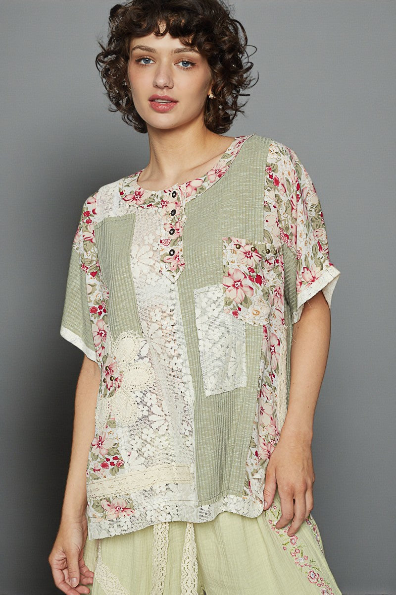 Woman wearing a floral and checkered top with a gray background