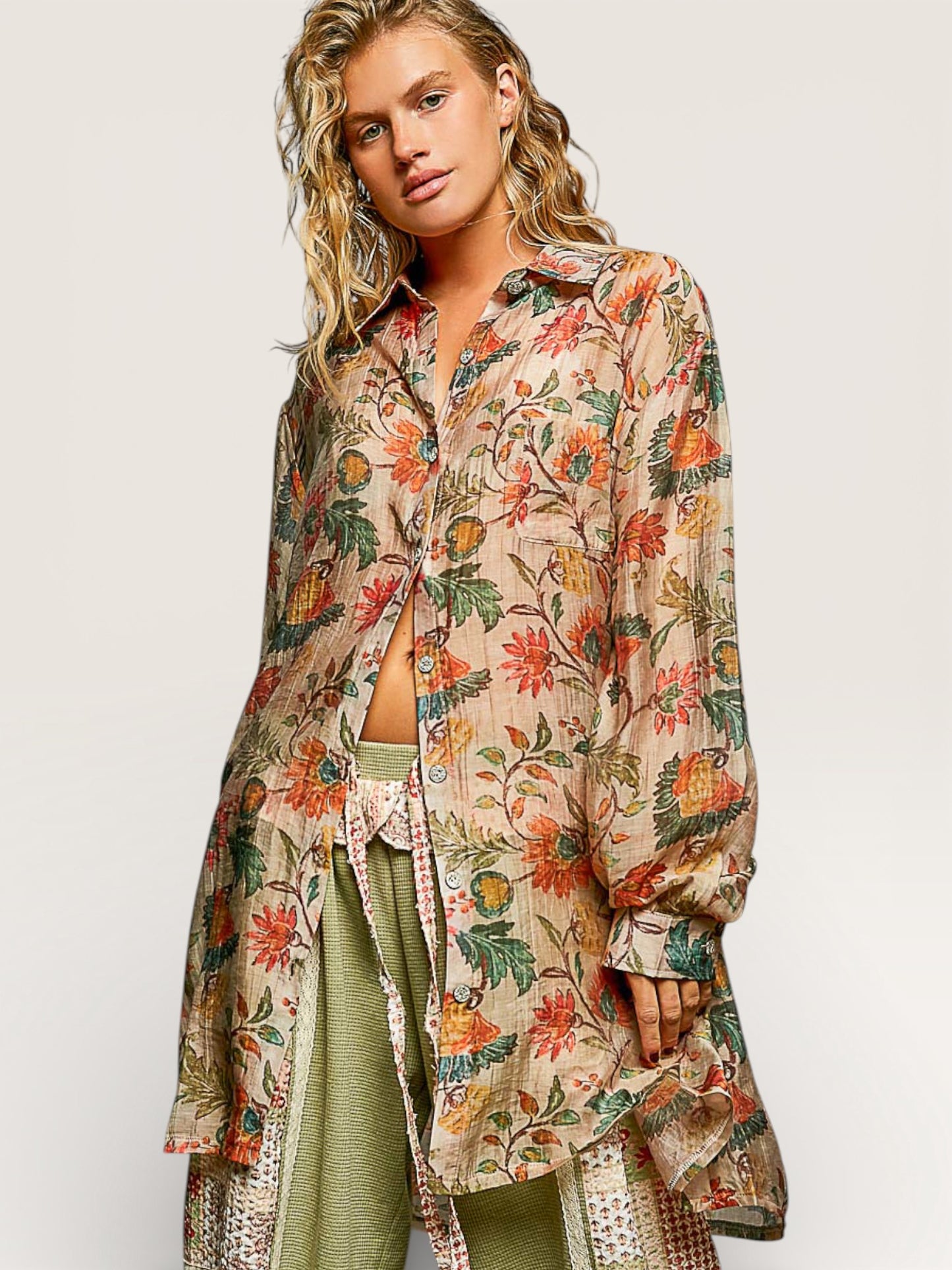 Woman wearing a floral patterned shirt over a green outfit on a white background