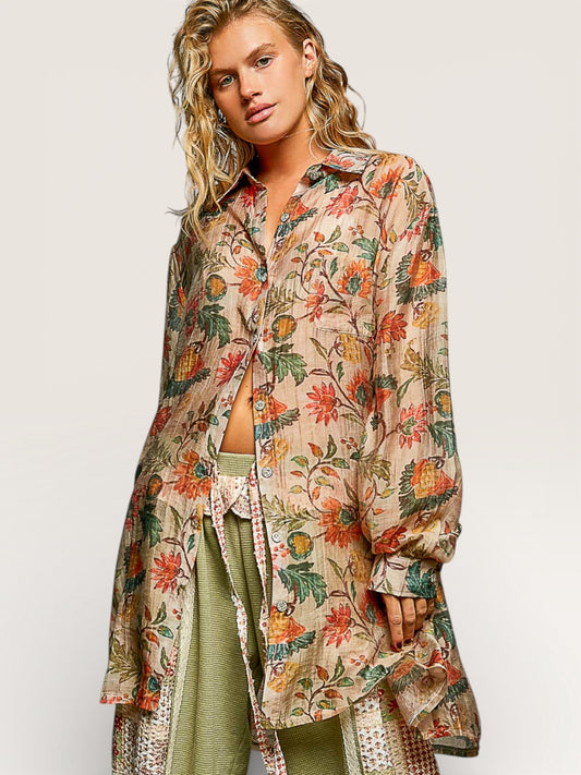 Woman wearing a floral patterned shirt over a green outfit on a white background